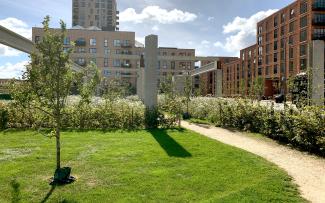 For the residents, having a park right at their front door is invaluable. © Malmos A/S / ZinCo Walking path through meadows with small fruit trees